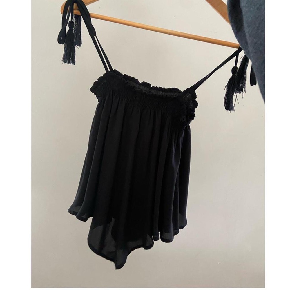 black top with tassel straps and pointed details